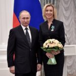 Russian President Vladimir Putin (left) awards Director of the Information and Press Department of the Ministry of Foreign Affairs of Russia Maria Zakharova (right).